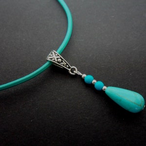 A turquoise leather cord and turquoise teardrop charm choker necklace. 13" - 14"