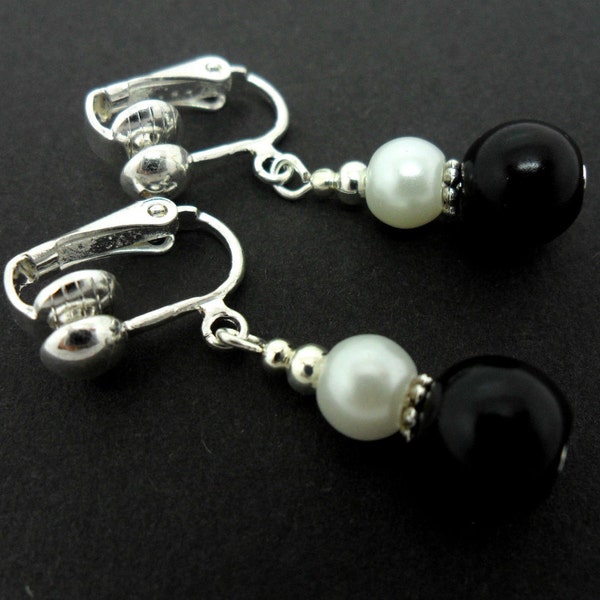 A pair of pretty black and white  glass pearl  bead  clip on dangly earrings.