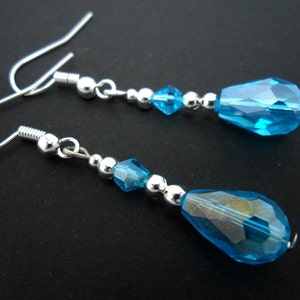 A pair of pretty silver plated aqua blue glass crystal  teardrop bead dangly earrings.