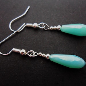 A pair of pretty silver plated blue glass crystal  teardrop bead dangly earrings.