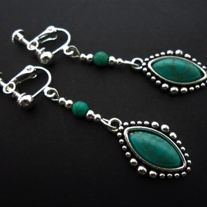 May include: A pair of silver clip-on earrings with turquoise stones and silver beads.
