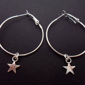 A pair of silver plated 35mm 1.5&quot; hoop and star charm earrings.