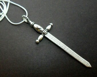 A tibetan silver sword themed necklace on an 18" silver plated snake chain.