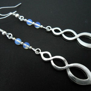 A pair of  hand made tibetan silver & opalite bead dangly twisty themed earrings. new.