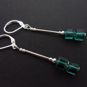 Un paio di graziosi orecchini pendenti fatti a mano in argento tibetano con perline di cristallo color verde acqua e chiusura a monachella. Nuovi.