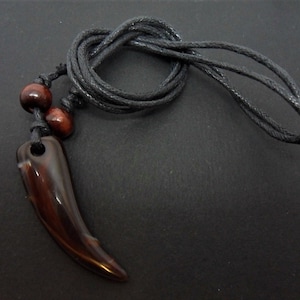 A mens/boys black cord surfer tribal brown tooth adjustable necklace. New.