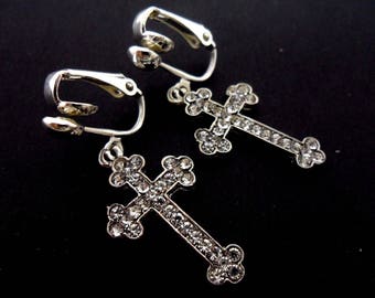 A pair of pretty rhinestone/diamante cross  dangly clip on earrings.