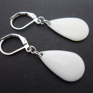 A pair of pretty white enamel teardrop dangly leverback hook earrings.