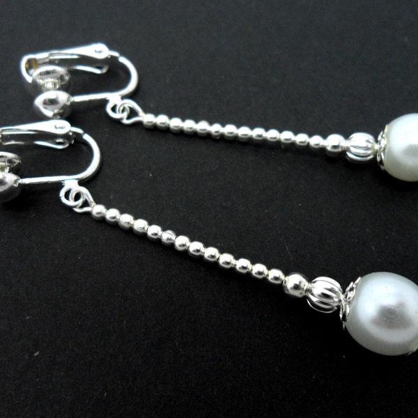 A pair of pretty white glass pearl bead  dangly clip on earrings.