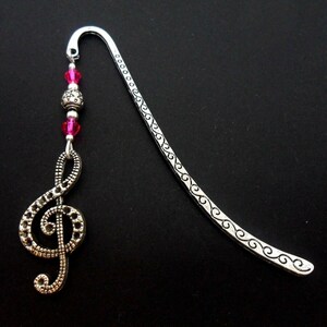 A tibetan silver treble clef musical note and pink crystal bead bookmark. 9cm long.