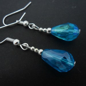 A pair of pretty silver plated blue glass crystal  teardrop bead dangly earrings.