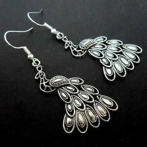 A pair of hand made peacock themed  dangly earrings with 925 solid silver hooks.