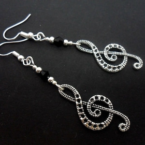 A pair of cute tibetan silver black crystal bead treble clef musical note  themed  dangly earrings.