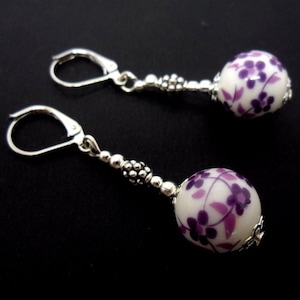 A pair of cute little hand made silver plated flower porcelain bead dangly leverback hook earrings. new.