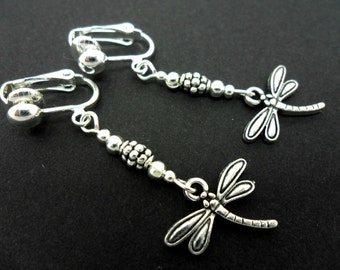 A pair of cute tibetan silver dragonfly themed  dangly clip on earrings.