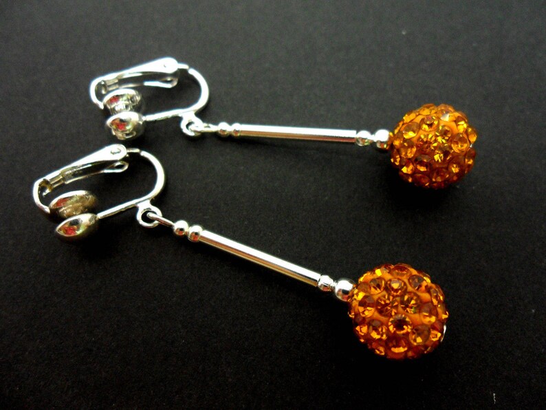 A pair of pretty silver plated gold colour shamballa style dangly clip on earrings. image 1