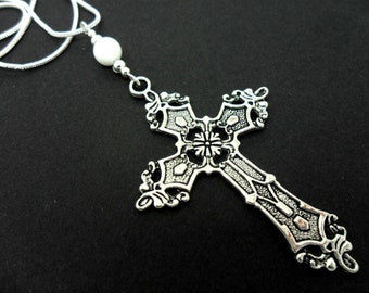 A lovely metal cross and white jade bead  pendant necklace.