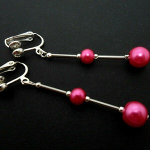 A pair of hand made pretty bright pink  glass pearl  dangly clip on earrings.