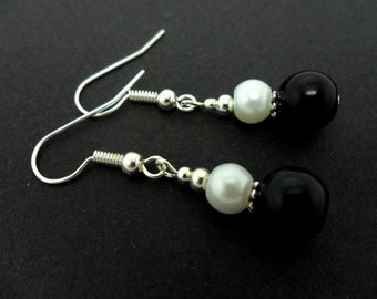 A pair of pretty black and white  glass pearl  bead  dangly earrings.