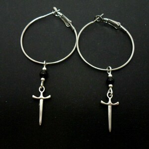 A pair of silver plated 35mm 1.5" hoop and dagger/knife charm earrings.