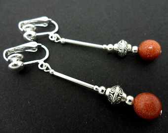 A pair of pretty brown goldstone  bead  dangly clip on earrings.