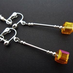 A pair of cute little hand made tibetan silver dangly amber colour crystal cube bead screw back clip on earrings. new.