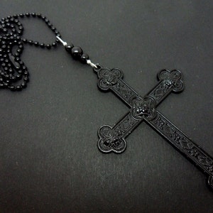 A lovely large black  cross themed  pendant necklace. 18&quot; black ball chain.