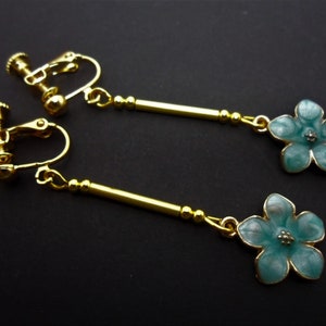 A pair of hand made blue enamel flower themed dangly screw back clip on earrings. New.