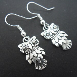 A pair of hand made tibetan silver dangly owl earrings. new.
