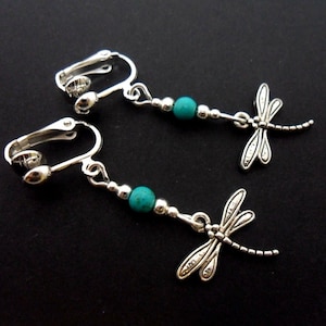 A pair of cute tibetan silver & turquoise bead dragonfly themed  dangly clip on earrings.