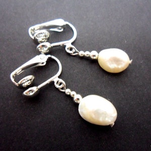 A pair of pretty white freshwater pearl  bead  dangly clip on earrings.