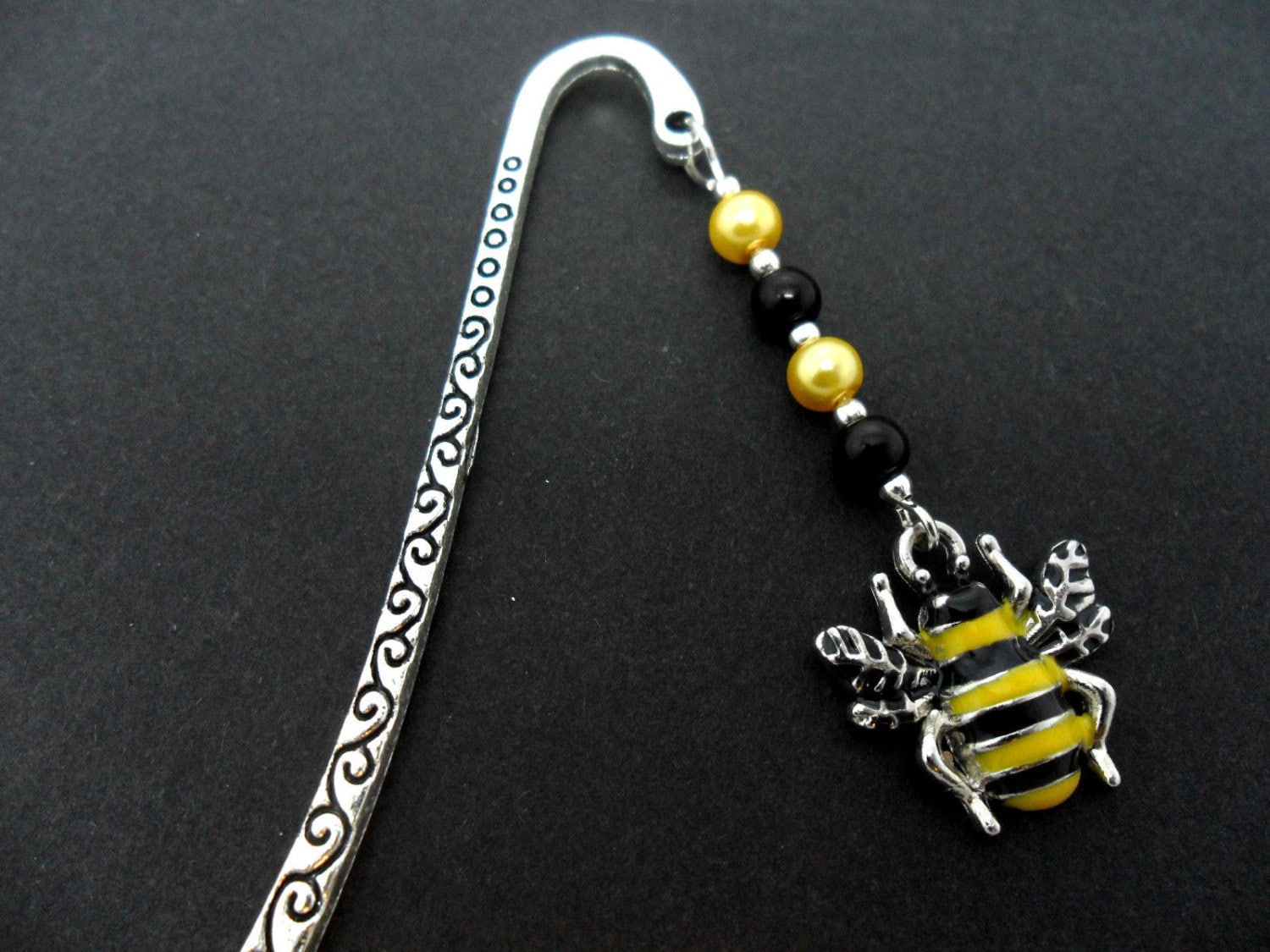A tibetan silver and honey bee  charm  bookmark. 9cm long.