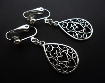 A pair of pretty hand made tibetan silver teardrop dangly clip on earrings. new.