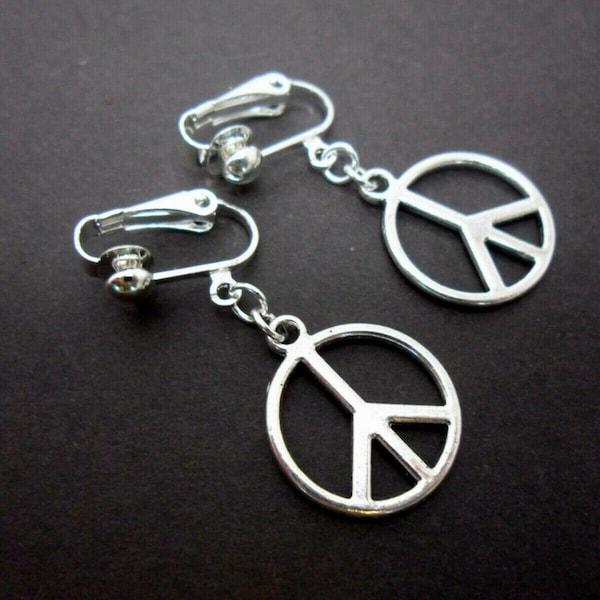 A pair of cute little tibetan silver peace sign dangly clip on earrings.