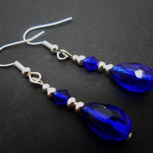 A pair of pretty silver plated cobalt blue glass crystal  teardrop bead dangly earrings.