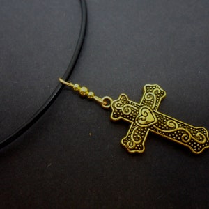 A leather cord 13&quot; - 14&quot; gold colour cross charm choker necklace.