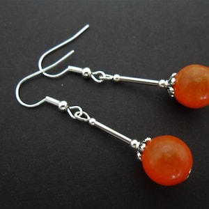 A pair of pretty orange jade bead  dangly earrings. new.
