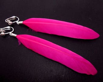 A pair of long bright pink feather clip on  dangly clip on earrings.