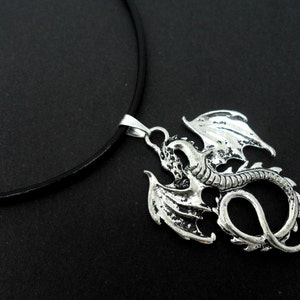 A leather cord 13" - 14" tibetan silver dragon charm choker necklace.
