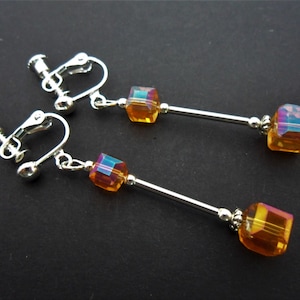A pair of cute little hand made tibetan silver dangly amber colour crystal cube bead screw back clip on earrings. new.