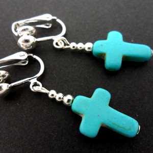 A pair of cute little hand made tibetan silver & turquoise cross dangly teardrop clip on earrings. new.