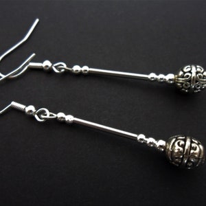 A pair of cute little hand made tibetan silver dangly earrings. new.
