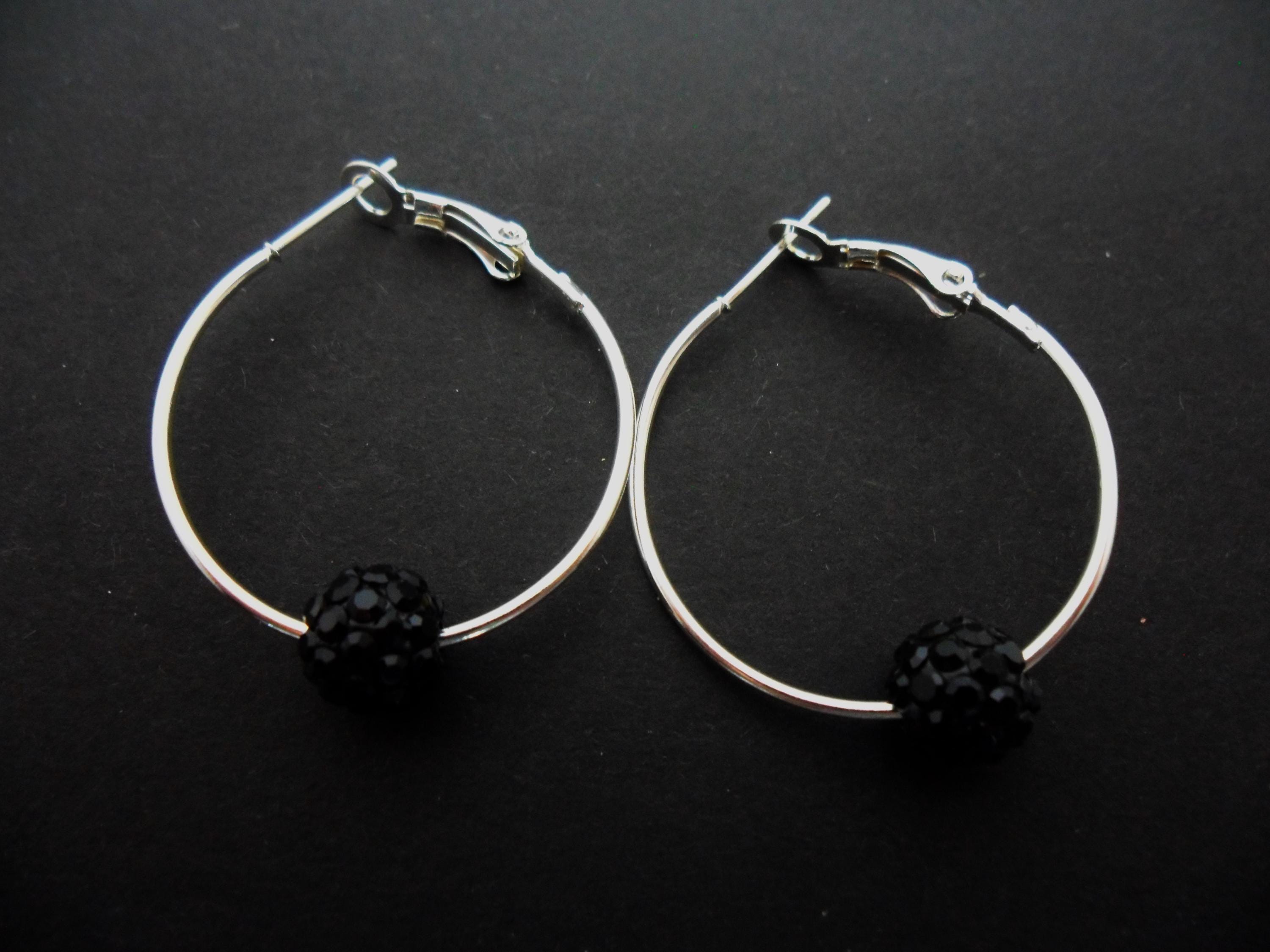 A pair of silver plated 30mm 1" hoop and black shamballa style bead earrings.