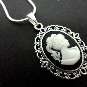 A lovely tibetan silver cameo  pendant necklace on an 18" snake chain.