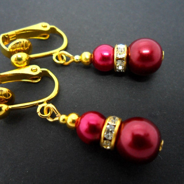 A pair of pretty gold plated dark red glass pearl  bead  dangly clip on  earrings.