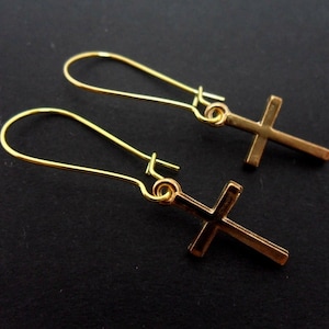 A pair of gold colour cross earrings on kidney wire hooks. New.