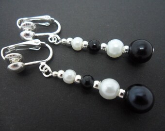 A pair of pretty  black and white glass pearl  bead  dangly clip on earrings.