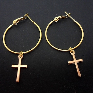 A pair of gold colour 30mm 1&quot; hoop and cross   charm earrings.