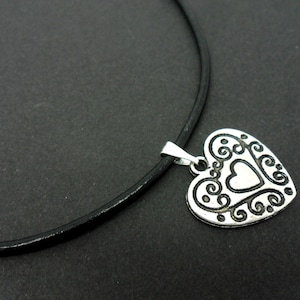 A leather cord 13" - 14" tibetan silver heart charm choker necklace.