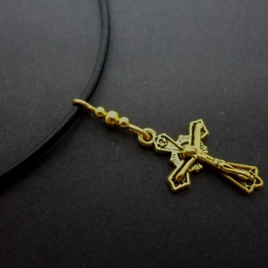 A leather cord 13&quot; - 14&quot; gold colour cross charm choker necklace.